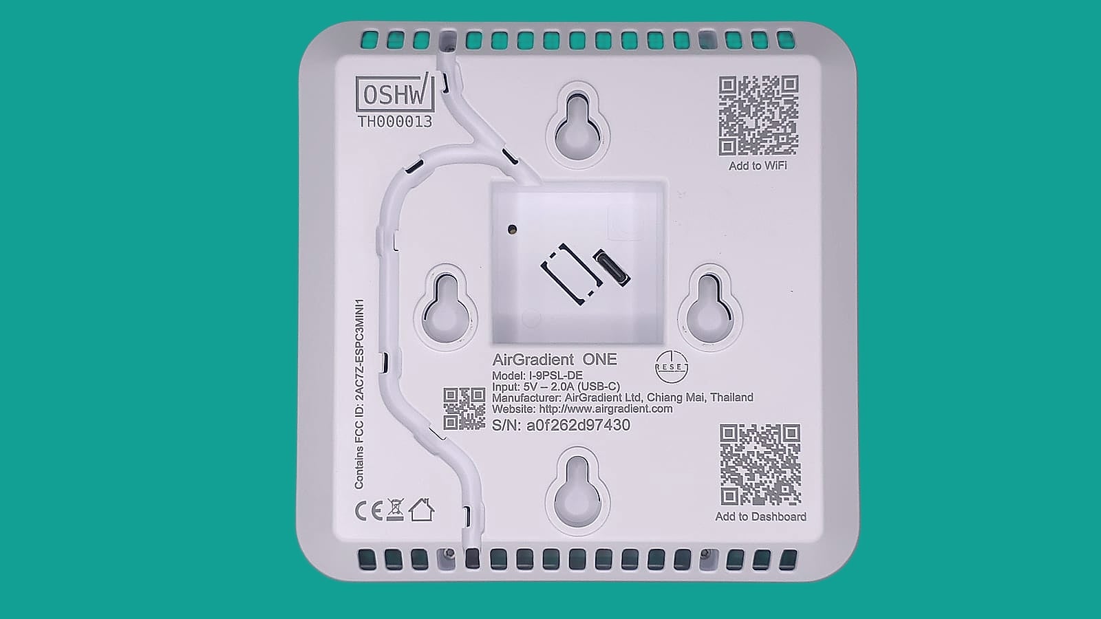 Underside of the AirGradient ONE showing its model number, FCC ID, OSHW certification and setup QR codes