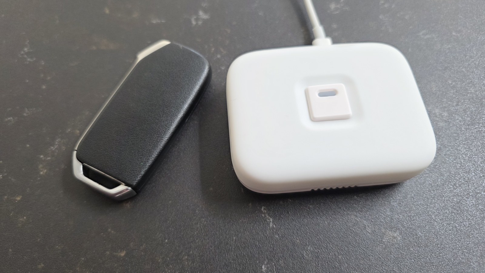 NodOn IRB-4-1-00 next to a car key fob for a real-world size comparison
